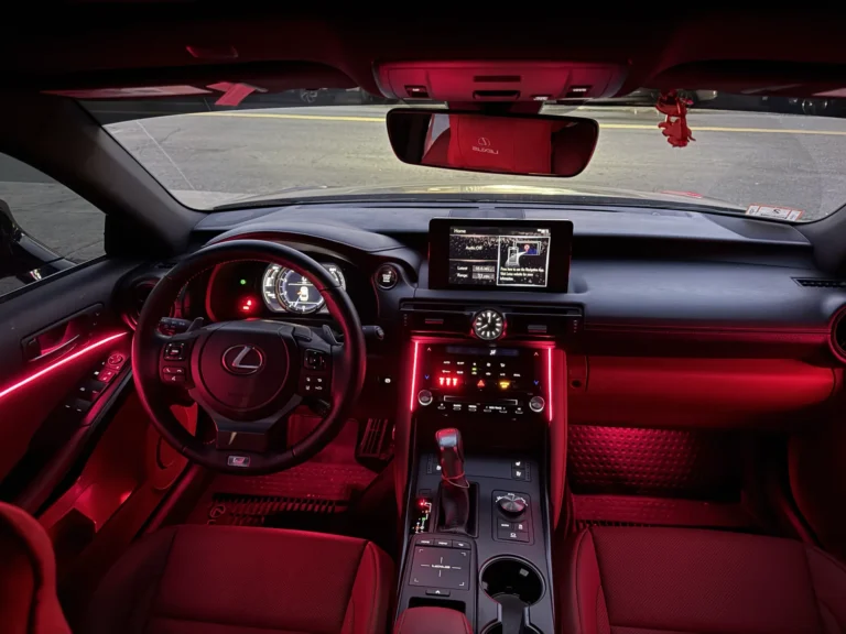 Lexus dashboard and front seats lit with red ambient lighting