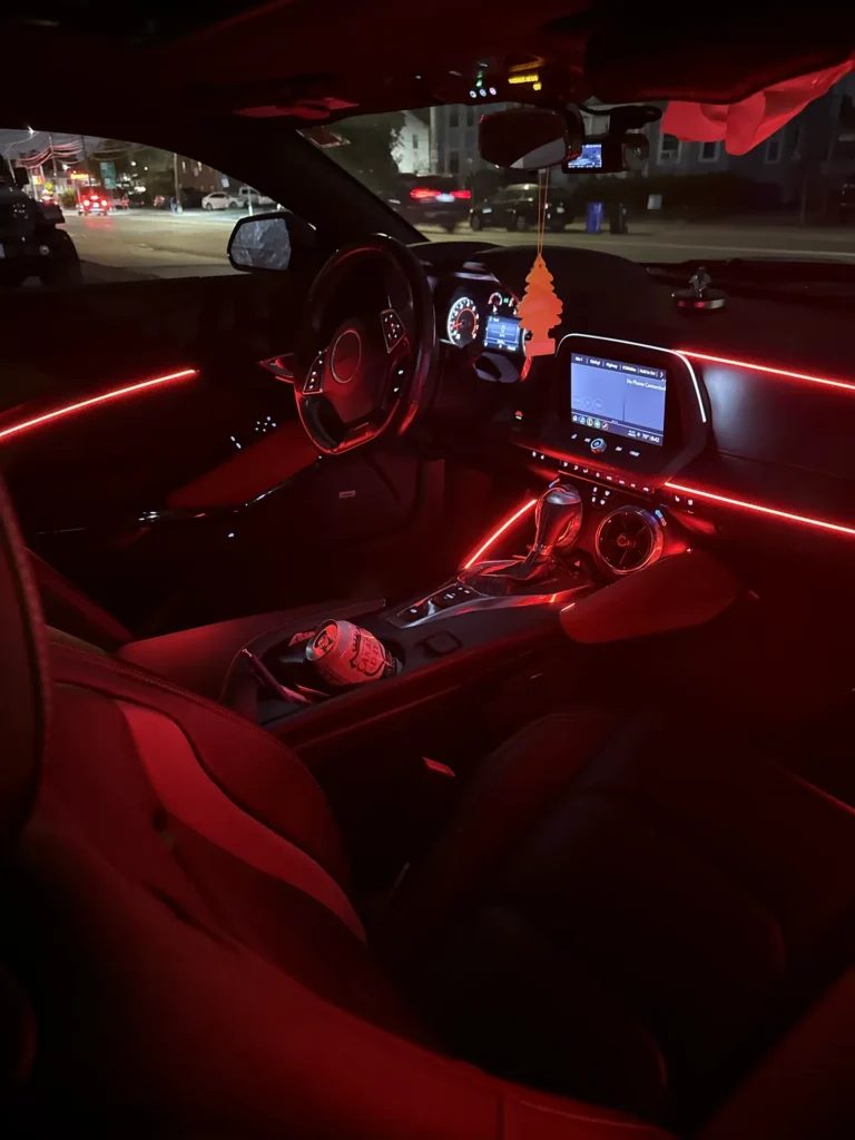 Lexus interior from the passenger side with red ambient lighting at night