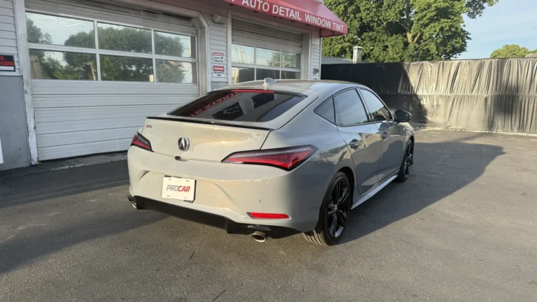 Gray Acura Integra with tinted rear and side windows outside Pro Car