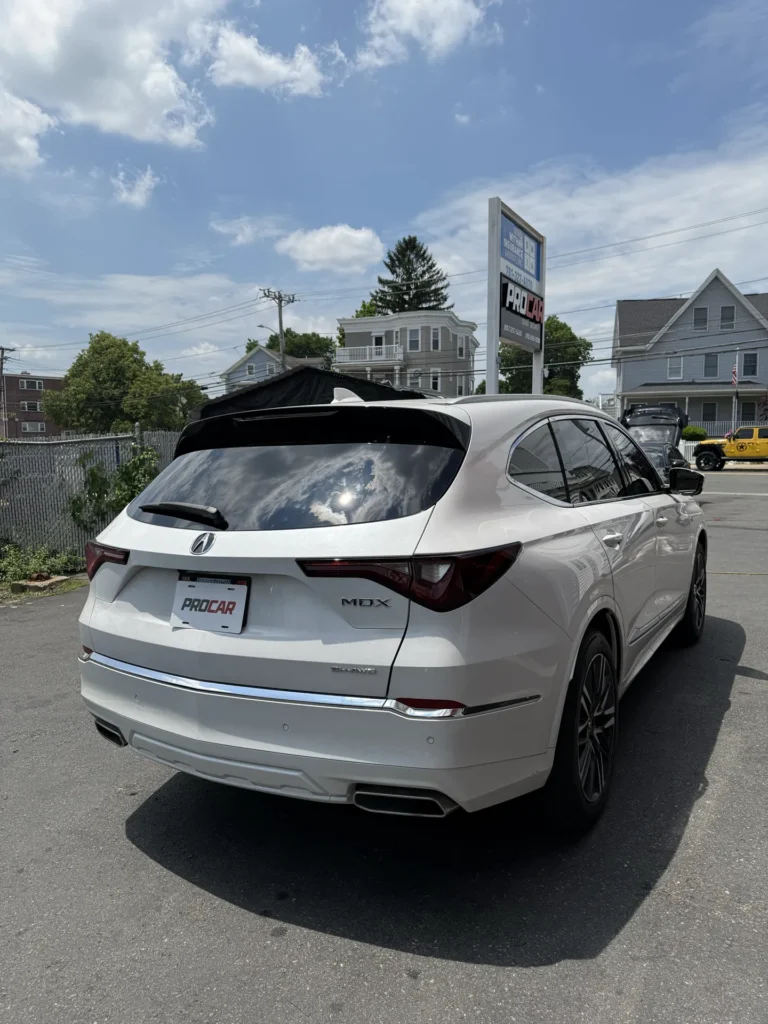 White Acura SUV with tinted rear and side windows