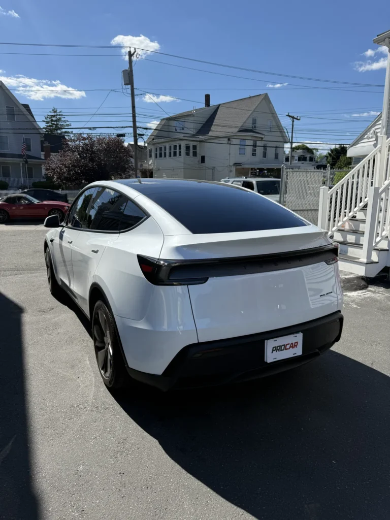 White Tesla Model Y with dark tinted windows